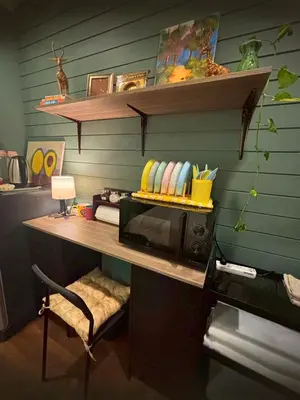 a kitchen with a desk with a microwave on a table at Hansa Heritage home in Khao San in Bangkok