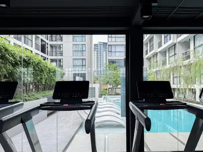 two laptops sitting on a table in front of a window at Serene Tropical 1BR - Ultra Fast Wifi - Sathorn in Bangkok