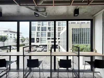 a room with tables and chairs and a large window at Serene Tropical 1BR - Ultra Fast Wifi - Sathorn in Bangkok