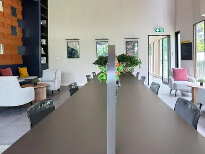 a large long table in a room with chairs at Stylish Tropical l 2BR - Ultra Fast Wifi - Sathorn in Bangkok