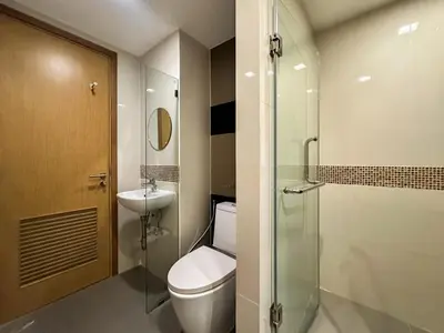 a bathroom with a toilet and a sink at Contemporary Premier 1BR - Ultra Fast Wifi - BTS Nana in Bangkok