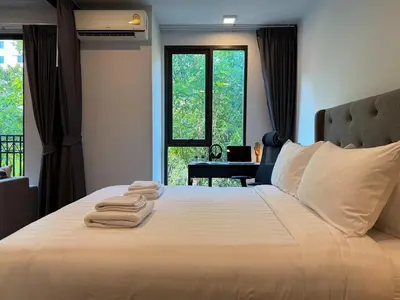 a bedroom with a large bed with towels on it at Contemporary Downtown - Ultra Fast WiFi - BTS Asoke in Bangkok