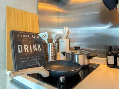 a pan sitting on top of a stove in a kitchen at Tropical Modern 1BR - Ultra Fast Wifi - Thong Lo in Bangkok