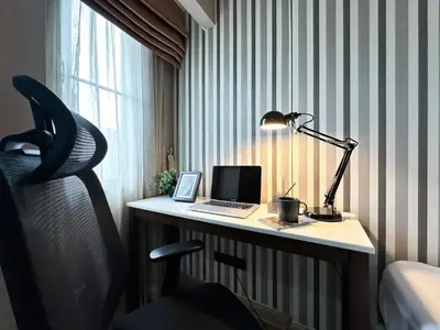 a desk with a laptop computer and a lamp on it at Tropical Modern 1BR - Ultra Fast Wifi - Thong Lo in Bangkok