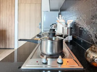 a pot on top of a stove in a kitchen at Exclusive Cityscape - Ultra Fast WiFi - BTS Thong Lor in Bangkok