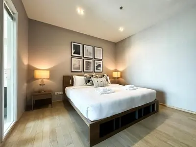 a bedroom with a large white bed with two lamps at Exclusive Cityscape - Ultra Fast WiFi - BTS Thong Lor in Bangkok