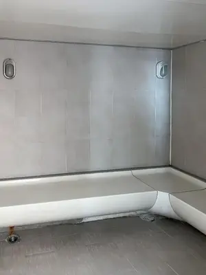 a white bath tub in a room with white walls at Centralized High-Rise - Ultra Fast Wifi - Ratchathewi in Bangkok