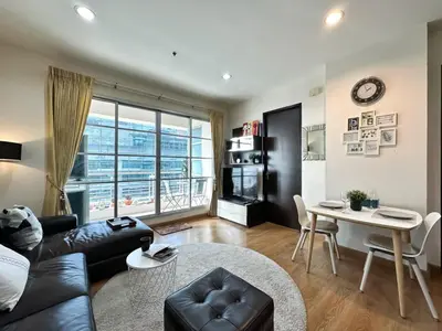 a living room with a couch and a table at Centralized High-Rise - Ultra Fast Wifi - Ratchathewi in Bangkok