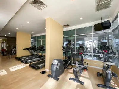 a gym with several treadmills and cardio machines at Contemporary Modern 1BR - Ultra Fast WiFi - On nut in Bangkok