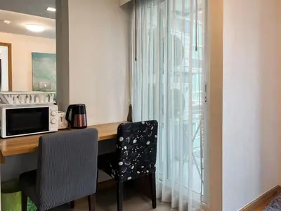 a kitchen with a desk with a microwave and a window at Expansive Premier 1BR - Ultra Fast Wifi - Phrom Phong in Bangkok