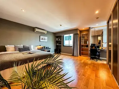 a bedroom with a bed and a desk in a room at Stylish Exquisite 1BR in Bangkok