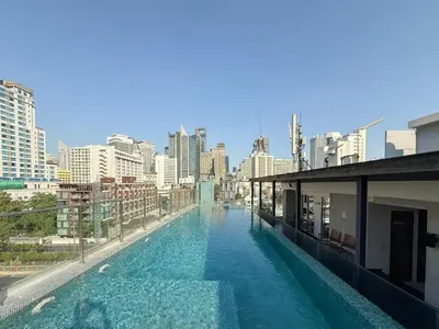 a swimming pool on top of a building with a city at Ruamrudee Modern - Ultra Fast WiFi - BTS Ploenchit in Bangkok