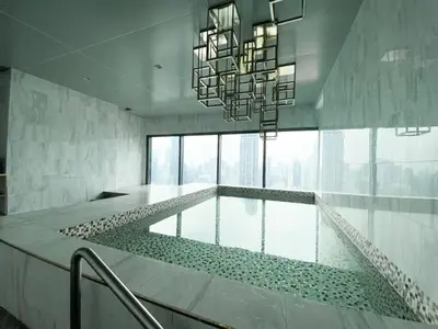 a large swimming pool with a chandelier in a building at Upscale Skyview 1BR - Ultra Fast Wifi - Chitlom in Bangkok