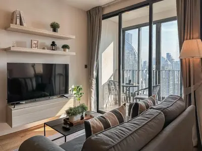 a living room with a couch and a large window at Upscale Skyview 1BR - Ultra Fast Wifi - Chitlom in Bangkok
