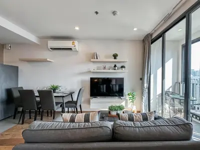 a living room with a couch and a table at Upscale Skyview 1BR - Ultra Fast Wifi - Chitlom in Bangkok