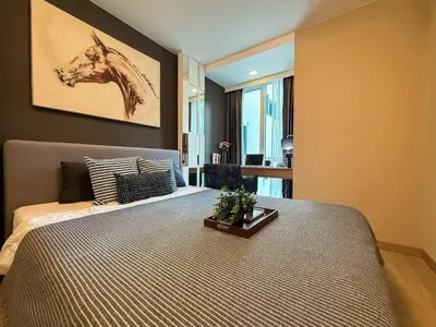a bedroom with a bed with a picture of a horse on the wall at Stylish Premier 1BR - Ultra Fast Wifi - BTS Nana in Bangkok