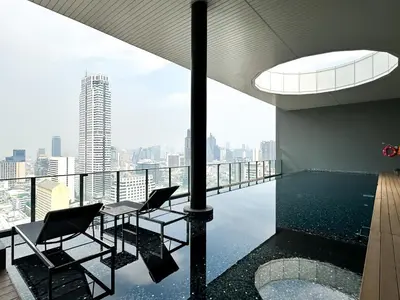 a room with a pool and chairs on the roof of a building at Contemporary Stylish 1BR - Ultra Fast Wifi - Silom in Bangkok