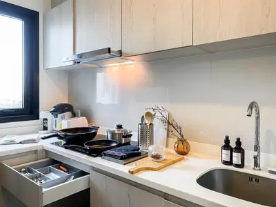a kitchen with a sink and a stove top oven at Luxury City-Scape 2BR - Ultra Fast Wifi - Asoke in Bangkok