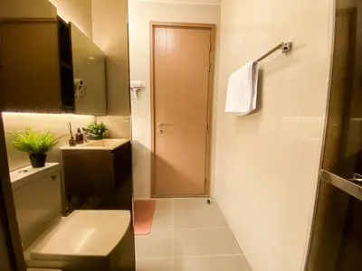 a bathroom with a toilet and a sink and a shower at Cityscape Modern Apt - Ultra Fast Wifi - Phra Khanong in Bangkok