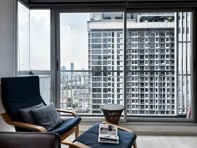 a living room with a view of a large window at Contemporary High-Rise 2BR - Ultra Fast Wifi - Sathorn in Bangkok