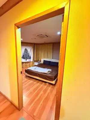 a view of a bedroom with a bed through a door at Royal Place Apartments in Bangkok