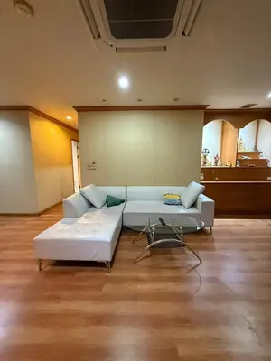 a living room with a white couch in a room at Royal Place Apartments in Bangkok
