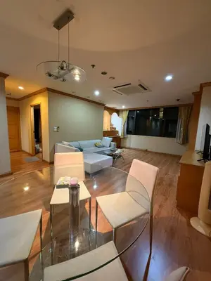a living room with a couch and a table and chairs at Royal Place Apartments in Bangkok