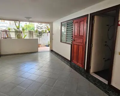 an empty room with a door and a tile floor at City Living in Bangkok