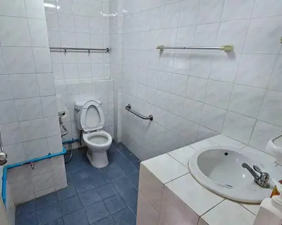 a white bathroom with a toilet and a sink at City Living in Bangkok