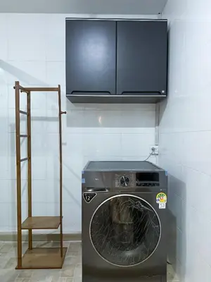 a washing machine in a room with a ladder at Delta9 Phrakanong 3 mins BTS Phrakanong in Bangkok