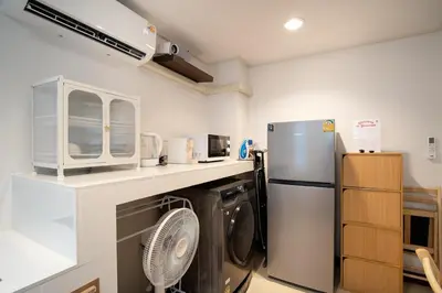 a kitchen with a refrigerator and a dishwasher at 2BR 1BA Home In Yaowarat 5 Min MRT Nivas Wanit ECO in Bangkok