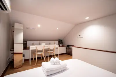 a bedroom with a bed and a table and chairs at 2BR 1BA Home In Yaowarat 5 Min MRT Nivas Wanit ECO in Bangkok