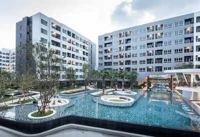 a large swimming pool in a building with two buildings at Gfeel X Elio Sukhumvit64 in Bangkok