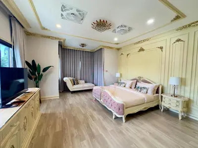 a large bedroom with a bed and a television at บ้านคุณนาย BaanKhunNaiPhaholyothin24 in Bangkok