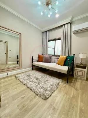 a living room with a bed and a window at บ้านคุณนาย BaanKhunNaiPhaholyothin24 in Bangkok