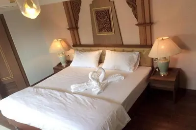 a bedroom with a bed with two hearts on it at Kim Hotel At Morleng in Bangkok