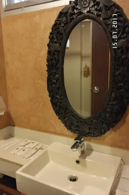 a bathroom with a sink and a mirror at Kim Hotel At Morleng in Bangkok