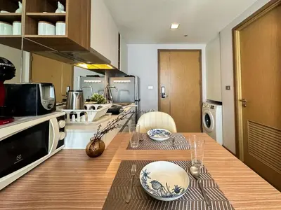 a kitchen with a table with plates on it at Contemporary Premier 1BR - Ultra Fast Wifi - BTS Nana in Bangkok