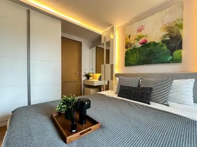 a bedroom with a bed with a tray on it at Contemporary Premier 1BR - Ultra Fast Wifi - BTS Nana in Bangkok