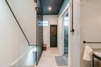 a hallway of a house with a glass staircase at Rare Bangkok Townhouse Perfect for Groups, 8 mins to Train in Bangkok