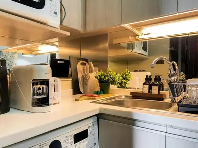 a kitchen with a sink and a counter top at Tropical Urban 43 Sqm - Ultra Fast Wifi - Thong Lo in Bangkok