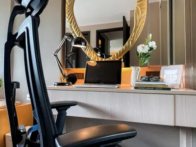 an office with a desk with a laptop and a chair at Tropical Urban 43 Sqm - Ultra Fast Wifi - Thong Lo in Bangkok