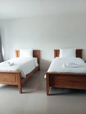 two beds sitting next to each other in a bedroom at VS Place in Nonthaburi