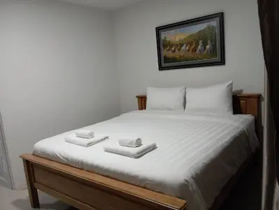 a bedroom with a bed with two towels on it at VS Place in Nonthaburi