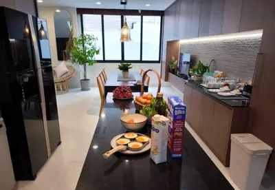a kitchen with a table with food on it at Studio Sukumvit 29 in Bangkok