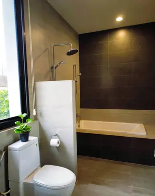 a bathroom with a toilet and a bath tub at Studio Sukumvit 29 in Bangkok
