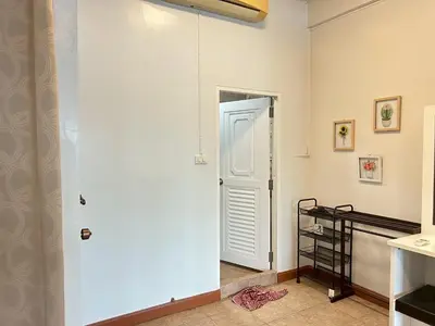 a hallway with a white door in a room at บ้านริมน้ำ bann rim num in Bangkok