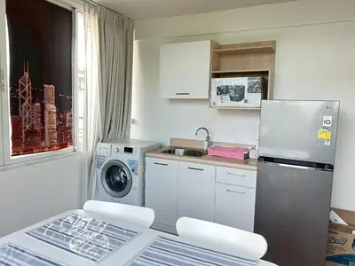 a small kitchen with a refrigerator and a washing machine at บ้านริมน้ำ bann rim num in Bangkok