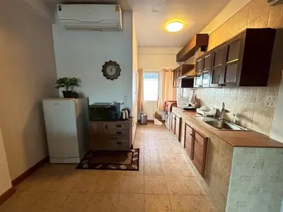 a kitchen with a refrigerator and a sink at บ้านริมน้ำ bann rim num in Bangkok
