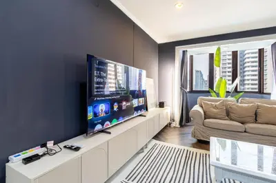 a living room with a large flat screen tv at Omni Nuvél 4 Sukhumvit Branded Suites in Bangkok
